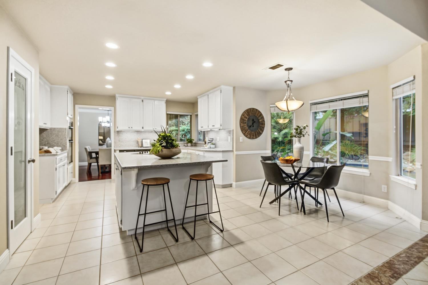 2760 Prestwick Drive Roseville, CA 95661 - Photo 17 of 45 a kitchen with a dining table chairs and large cabinets