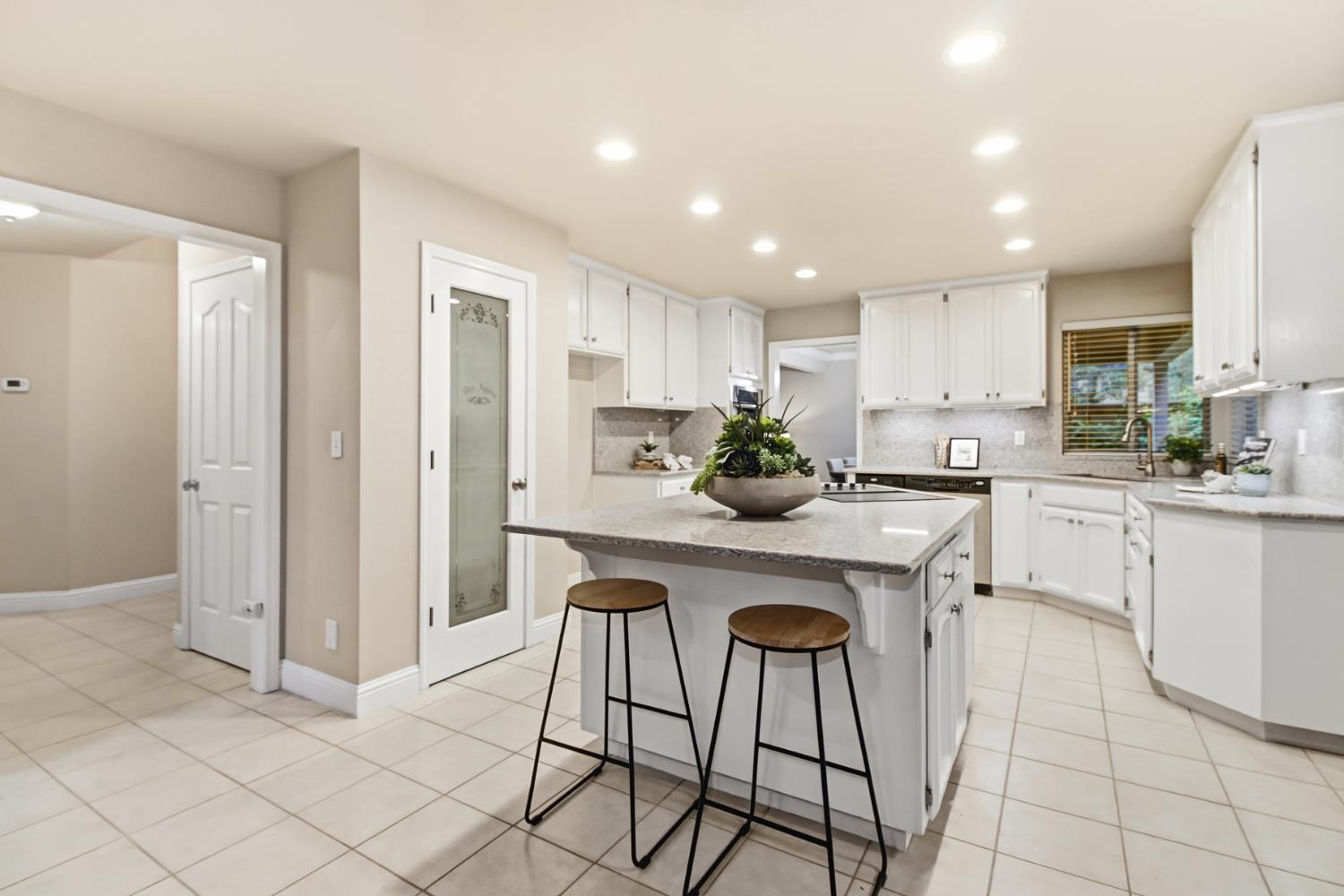 2760 Prestwick Drive Roseville, CA 95661 - Photo 19 of 45 a kitchen with stainless steel appliances kitchen island granite countertop a refrigerator and cabinets