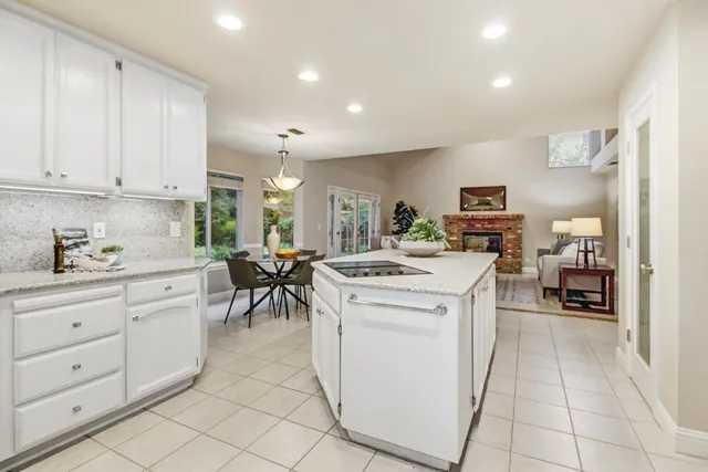 a kitchen with cabinets and chairs