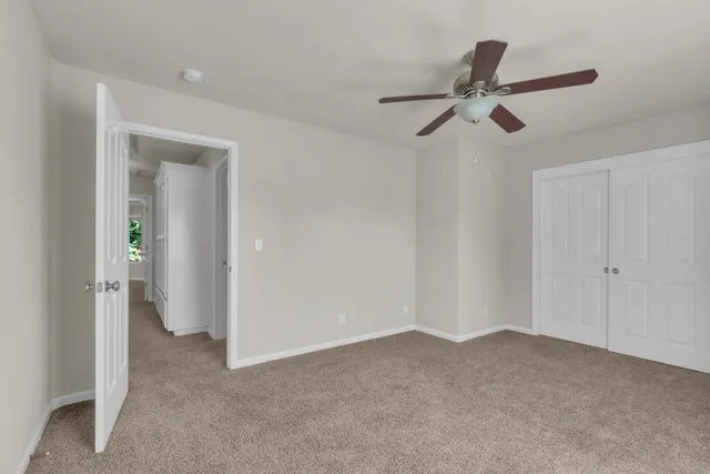 a view of a livingroom with a ceiling fan and entryway