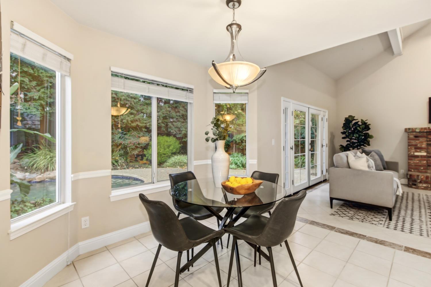 2760 Prestwick Drive Roseville, CA 95661 - Photo 24 of 45 a view of a dining room with furniture wooden floor and a chandelier