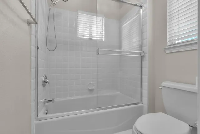 a bathroom with a shower and a toilet