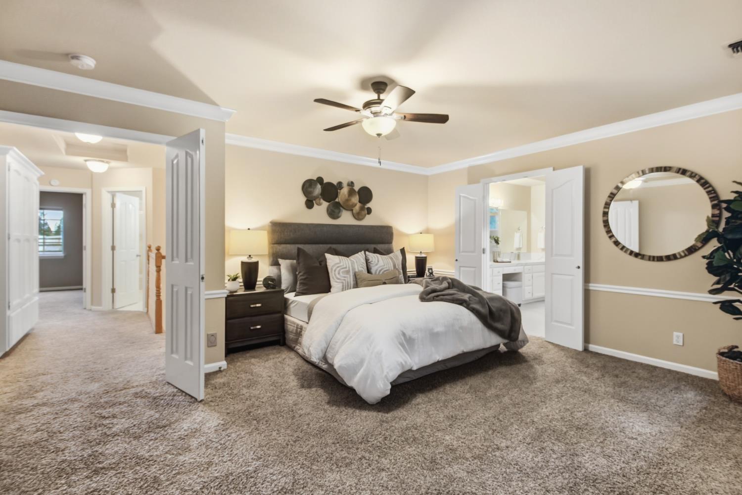 2760 Prestwick Drive Roseville, CA 95661 - Photo 26 of 45 a bedroom with a bed and a chandelier