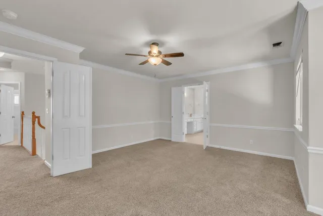 a view of an empty room with a ceiling fan