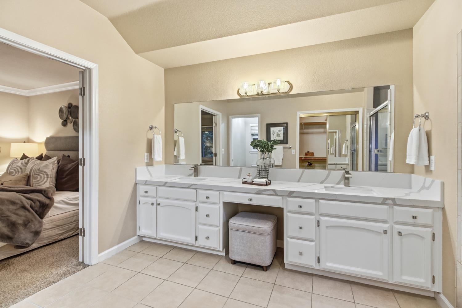 2760 Prestwick Drive Roseville, CA 95661 - Photo 30 of 45 a en suite bathroom with a granite countertop sink and a mirror