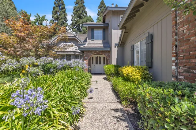 a view of a pathway with a house in the background
