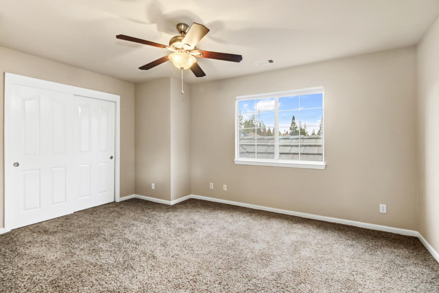 2760 Prestwick Drive Roseville, CA 95661 - Photo 32 of 45 an empty room with windows and fan