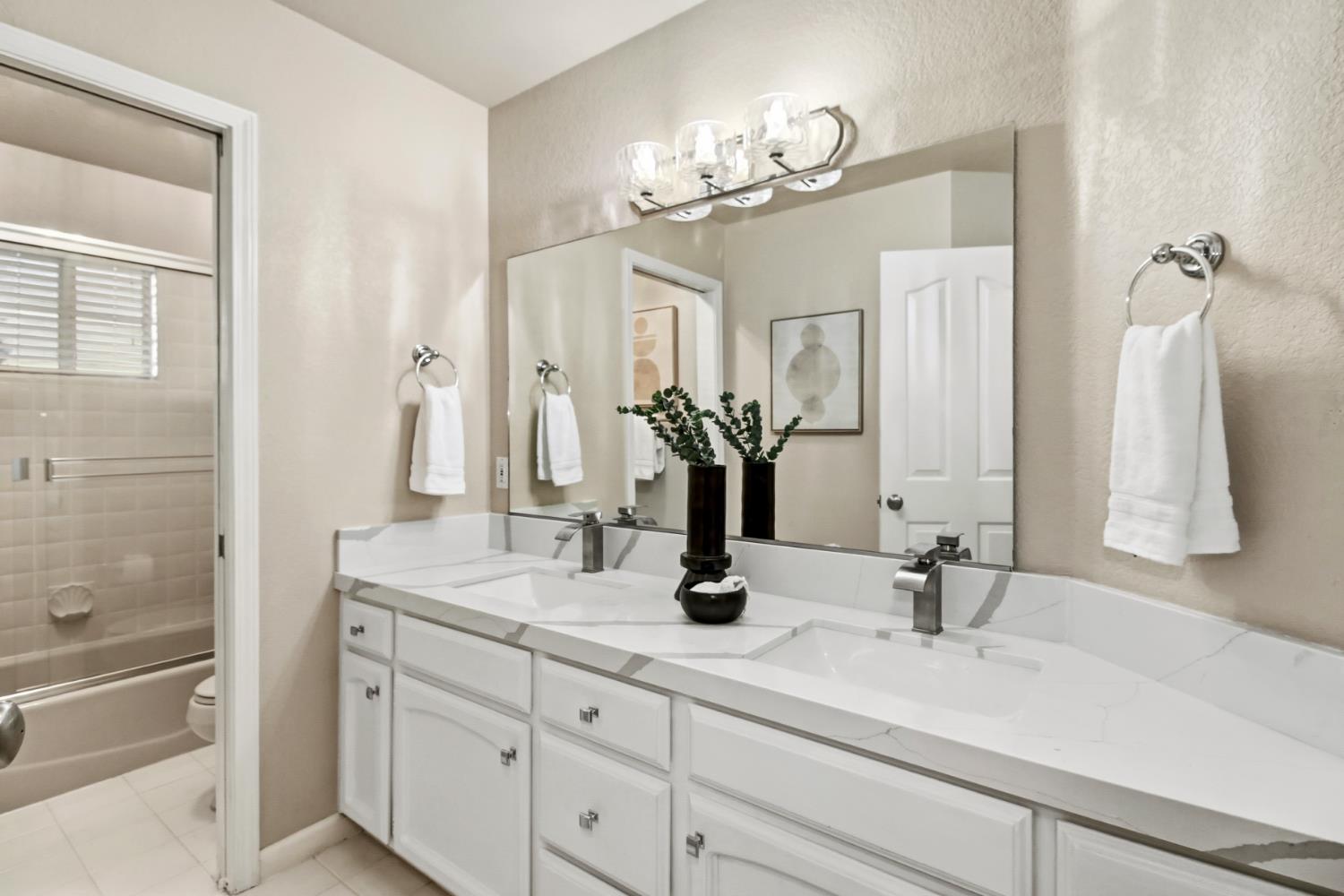 2760 Prestwick Drive Roseville, CA 95661 - Photo 33 of 45 a bathroom with double vanity sinks a toilet a mirror and shower