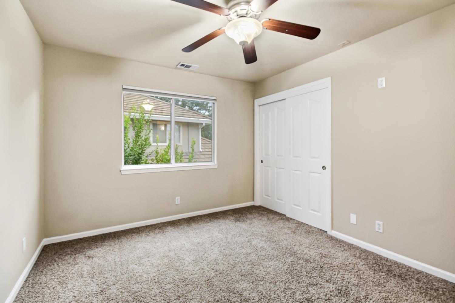 2760 Prestwick Drive Roseville, CA 95661 - Photo 34 of 45 an empty room with a window and a fan