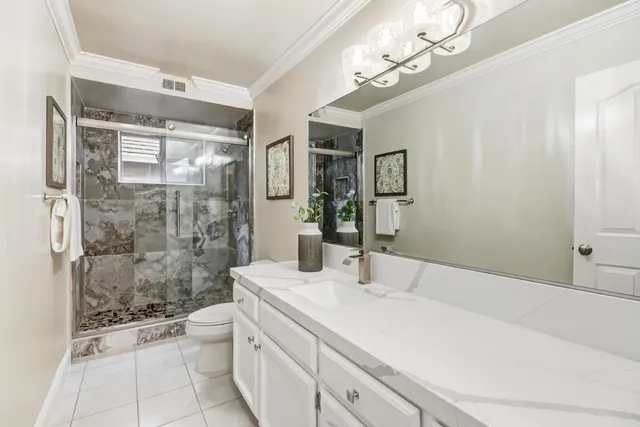 a bathroom with a window and a white rack