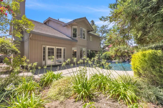 an aerial view of a house with garden space and street view