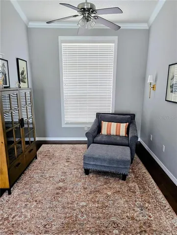 a bedroom with a bed rug dresser and wooden floor