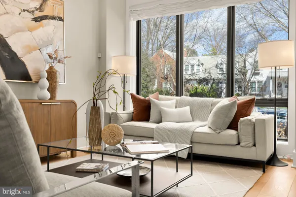 a living room with furniture and a floor to ceiling window