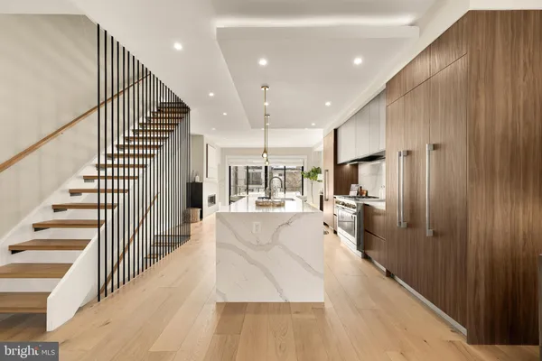 a kitchen with stainless steel appliances granite countertop a sink a stove and a refrigerator