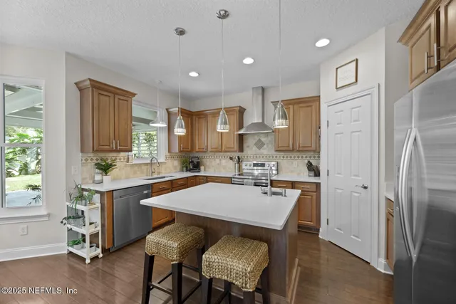 a kitchen with stainless steel appliances a sink stove and cabinets