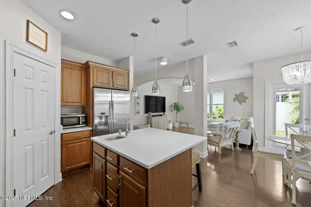 a view of a dining room with furniture a chandelier and wooden floor