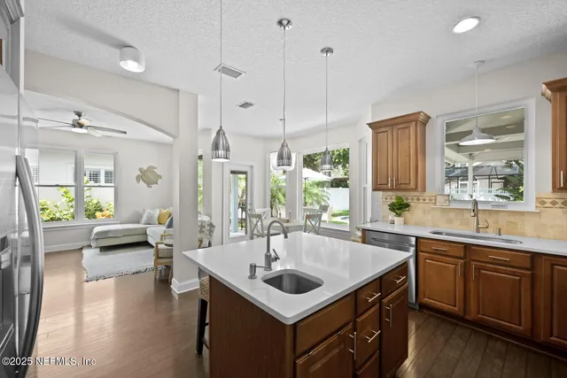 a view of a dining room with furniture a chandelier and wooden floor