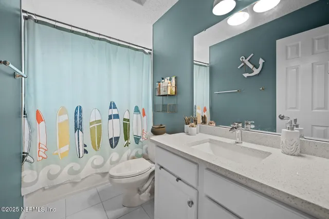 a view of a patio with table and chairs under an umbrella