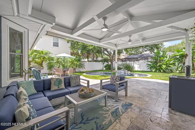a view of a house with swimming pool and sitting area