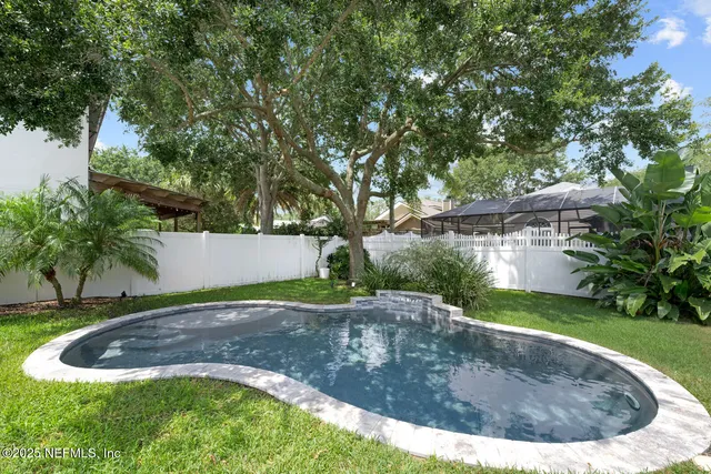 a view of a house with pool and sitting area