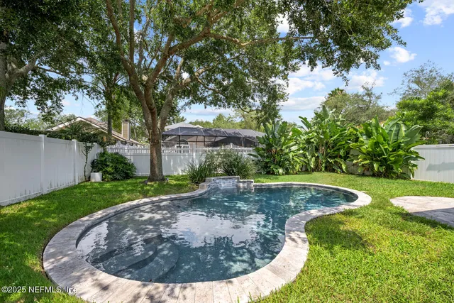 a view of a house with backyard sitting area and swimming pool