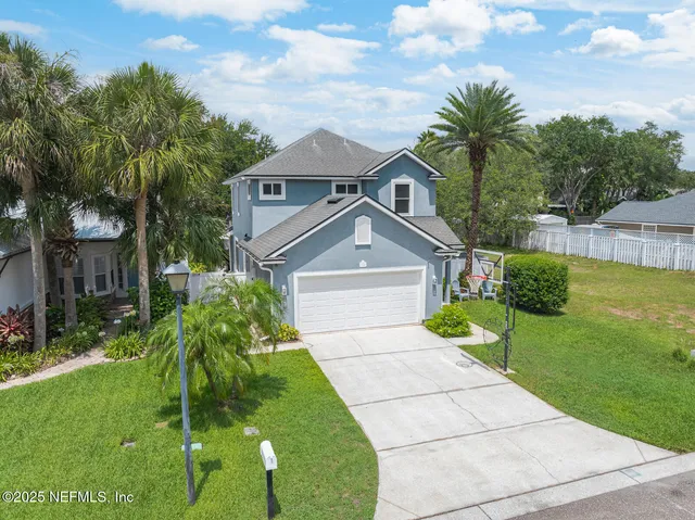 an aerial view of multiple houses with yard
