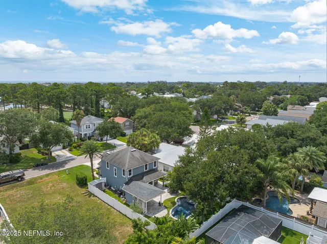 an aerial view of residential houses with outdoor space and swimming pool