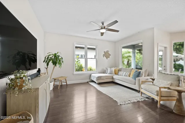 a kitchen with stainless steel appliances granite countertop a table chairs sink refrigerator and cabinets