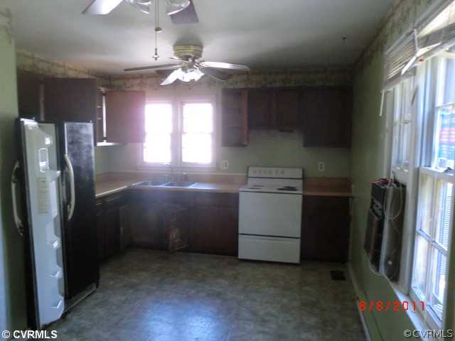 6412 Omo Road Richmond, VA 23234 - Photo 5 of 6 a kitchen with stainless steel appliances a refrigerator sink and cabinets