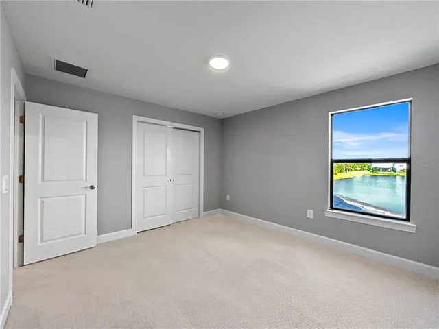 a bathroom with a granite countertop toilet and a sink