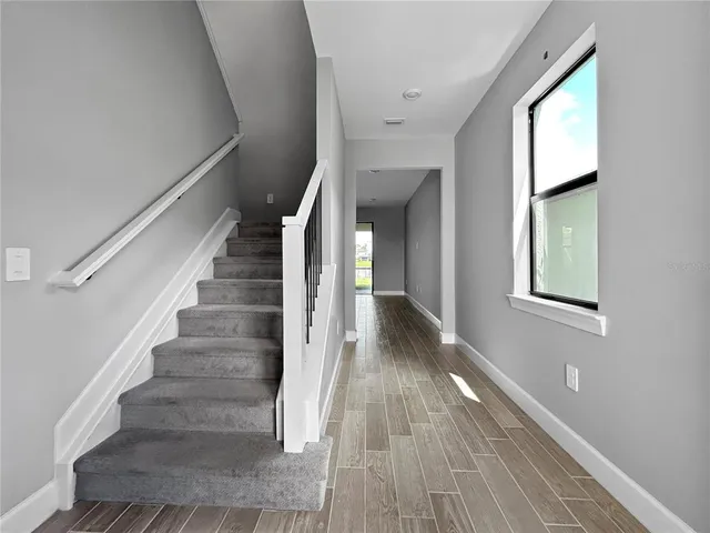 a view of entryway and hall with wooden floor