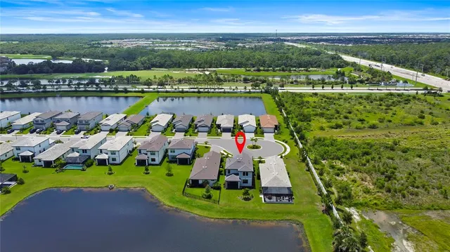 a view of lake with a table and chairs under an umbrella