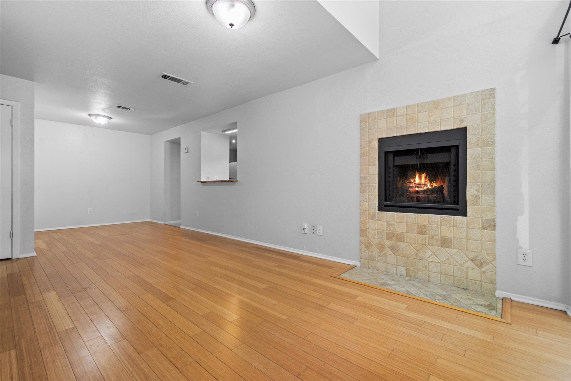 3627 Menchaca Road, Unit 204 Austin, TX 78704 - Photo 4 of 23 Warm hardwood floors complement a tiled fireplace in this inviting living space.