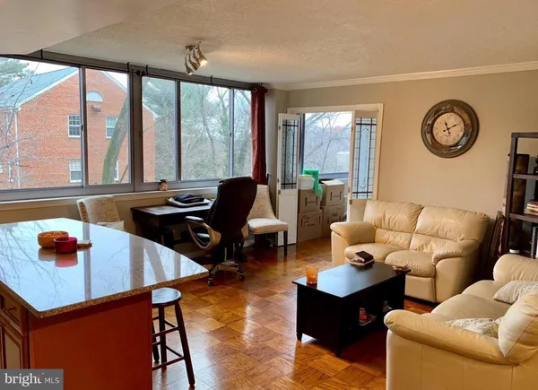 a living room with furniture and large windows