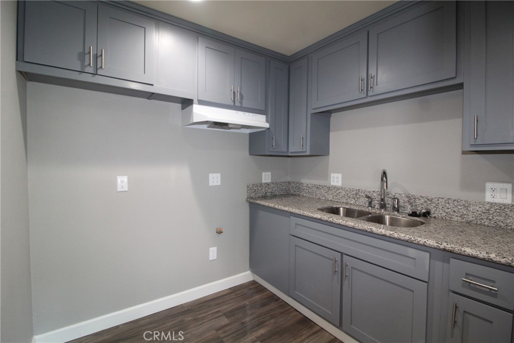 4986 Southern Avenue, Unit E South Gate, CA 90280 - Photo 5 of 9 a kitchen with a sink and cabinets