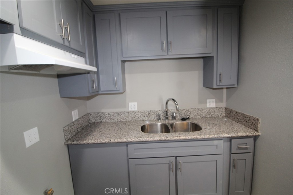 4986 Southern Avenue, Unit E South Gate, CA 90280 - Photo 6 of 9 a kitchen with a sink and cabinets
