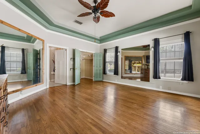 a bathroom with a granite countertop toilet sink and mirror