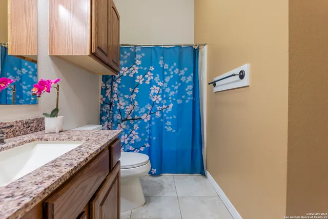 a bathroom with a sink a toilet and a mirror