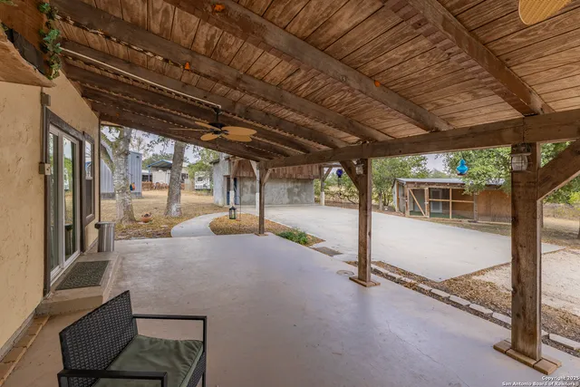 a view of a hallway with wooden floor and chandelier