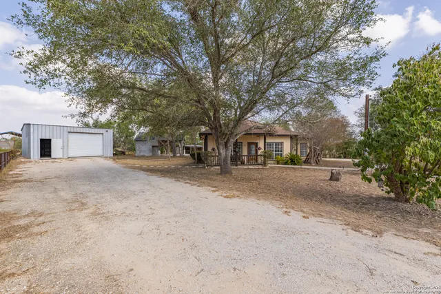 an aerial view of house with yard