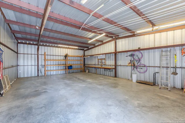 an aerial view of a house with a yard and a fountain
