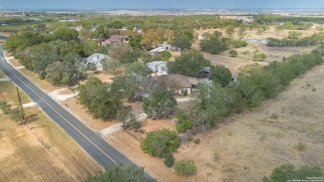 an aerial view of a house with a yard