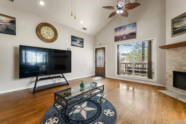 a living room with furniture a clock and a window