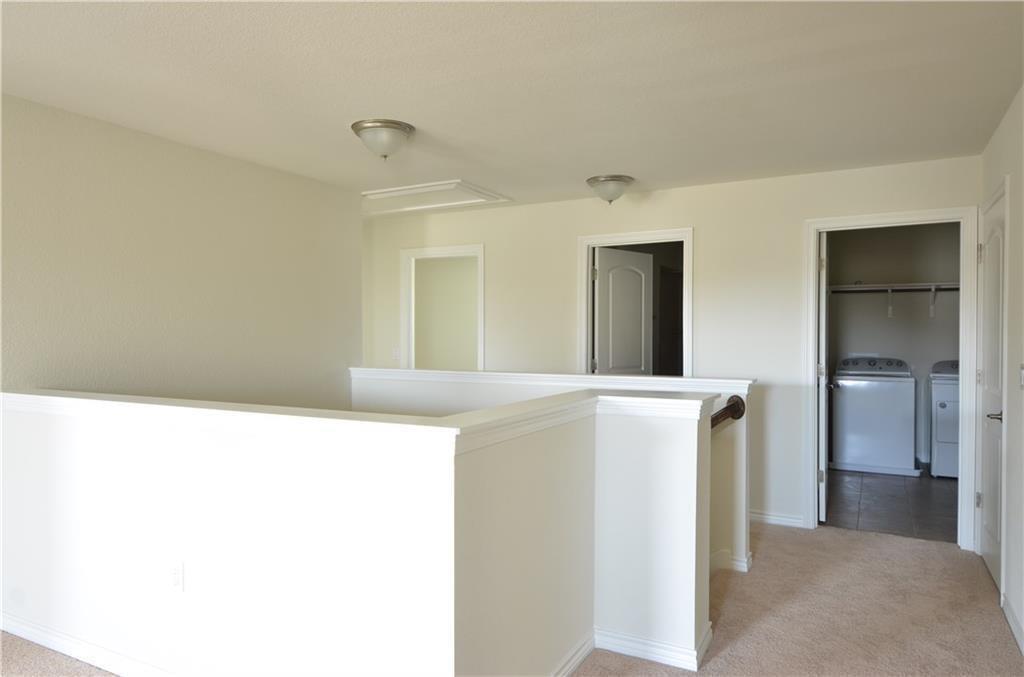 14403 McCoy Loop Austin, TX 78717 - Photo 15 of 29 A versatile open landing provides easy access to an interior laundry area.
