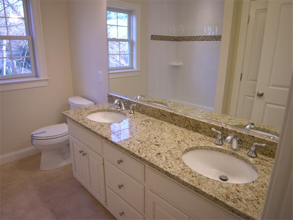 73 Berkshire Road Needham, MA 02492 - Photo 22 of 28 a bathroom with a granite countertop double vanity sink and a mirror