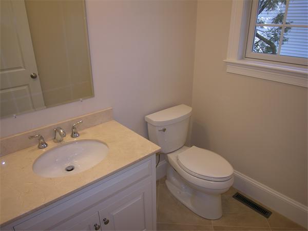 73 Berkshire Road Needham, MA 02492 - Photo 25 of 28 a white toilet sitting next to a bathroom sink