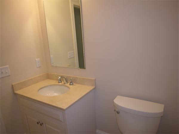 73 Berkshire Road Needham, MA 02492 - Photo 27 of 28 a bathroom with a sink a toilet and mirror