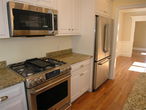 73 Berkshire Road Needham, MA 02492 - Photo 8 of 28 a kitchen with stainless steel appliances granite countertop a stove microwave and refrigerator