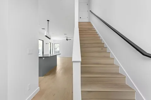 a view of entryway and hall with wooden floor