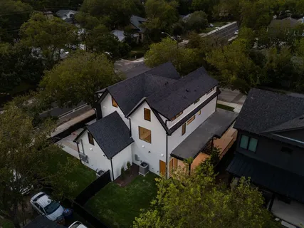 an aerial view of a house with garden space and street view